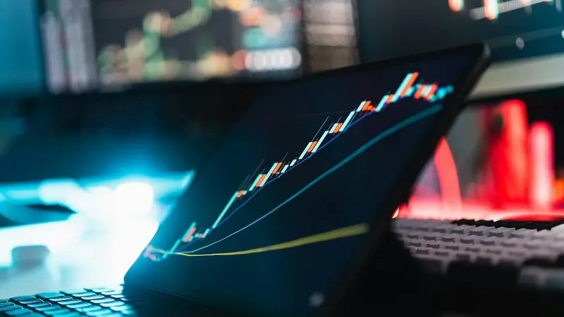 Automated crypto trading setup with laptop and trading desk
