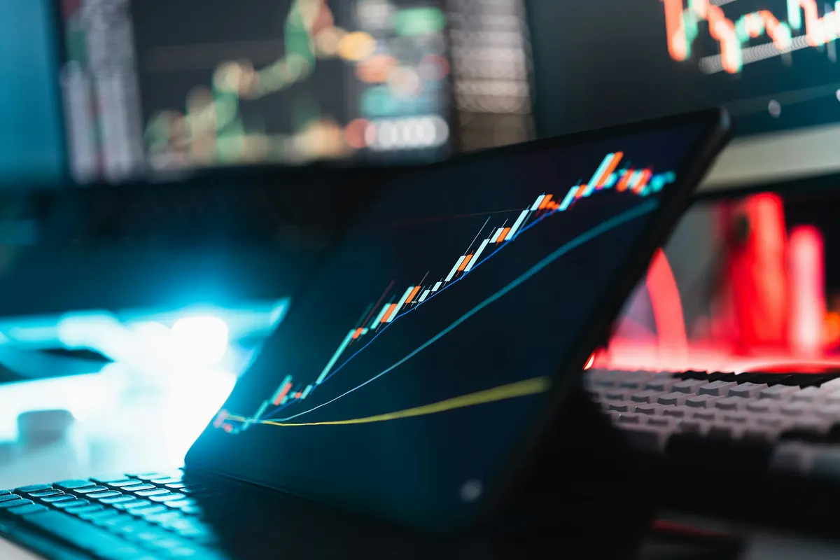 Automated crypto trading setup with laptop and trading desk